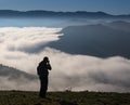 Man hiking in mountains photographing and enjoying the good weather in aiako harriak natural park