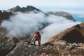 Man hiking in mountains travel lifestyle climbing solo to summit above clouds Royalty Free Stock Photo