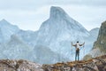 Man hiking in Norway traveler happy raised hands enjoying mountain view traveling backpacking outdoor Royalty Free Stock Photo