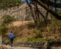 Man with hiking pole on sidewalk