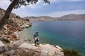 A man hiking at the scenic sea coast at Symi island, Greece. Royalty Free Stock Photo