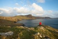 Man hiking through Scottish Highlands along rugged coastline