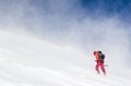 Man hiking in a snowed steep slope