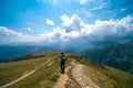 Man hiking to Koruldi lakes, beautiful view of Great Caucasus mountains close to Mestia in Upper Svaneti, Georgia. Summer day Royalty Free Stock Photo