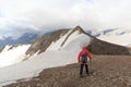 Man hiking towards summit Mittlerer BÃ¤renkopf and mountain snow and glacier panorama in Glockner Group, Austria Royalty Free Stock Photo