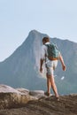 Man hiking traveling alone in Norway vacations backpacking eco tourism in mountains