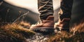 Man hiking up mountain trail close-up of leather hiking boots. Generative AI