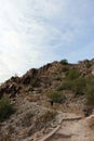 A male hiker going up the Piestewa Summit Trail in the mountains of Phoenix, Arizona