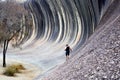 Man hiking on the Wave rock in Hyden Western Australia Royalty Free Stock Photo