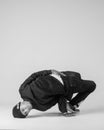 A man hip hop dancer or bboy freezes in one pose on a white background. Bboy doing stylish stunts. Royalty Free Stock Photo