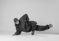 A man hip hop dancer or bboy freezes in one pose on a white background. Bboy doing stylish stunts. Royalty Free Stock Photo