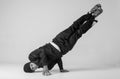 A man hip hop dancer or bboy freezes in one pose on a white background. Bboy doing stylish stunts. Royalty Free Stock Photo