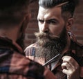 Man hipster cutting beard. Barber scissors and straight razor, barber shop, suit. Vintage barber shop, shaving. Portrait Royalty Free Stock Photo