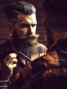 Man hipster cutting beard