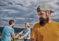 Man hipster feels lonely couple dating behind him. Unlucky romantic life. Guy adult still lonely while friends happy