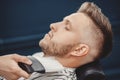 Man hipster having barber shave barbershop hair machine