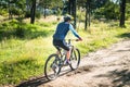 Man on his back riding a mountain bike in the forest Royalty Free Stock Photo