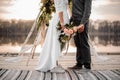 Man and his bride standing on the wooden rostrum