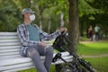 Man with his bicycle resting in a city park Royalty Free Stock Photo