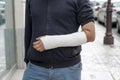 Man with his broken arm. Arm in cast. Royalty Free Stock Photo