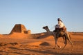 Man with his camel in a desert in Sudan