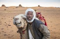 Man with his camel in a desert in Sudan Royalty Free Stock Photo