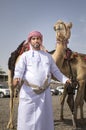 Man with his camels in a countryside of Oman Royalty Free Stock Photo