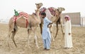 man with his camels in Rub al Khali Desert at the Empty Quarter, in Abu Dhabi, UAE