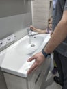 a man with his daughter chooses a washbasin in a furniture hypermarket