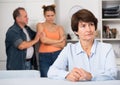 Man and his daughter are sympathying their sad mother who is sitting at the table Royalty Free Stock Photo