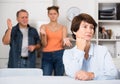 Man and his daughter are sympathying their sad mother who is sitting at the table Royalty Free Stock Photo