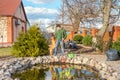 Man with his dog cleans a garden pond from falling leaves Royalty Free Stock Photo