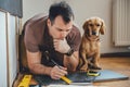 Man and his dog doing renovation work at home Royalty Free Stock Photo