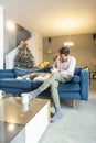 Man and his dog are sitting in the living room with Christmas decorations Royalty Free Stock Photo