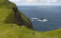 Man and his dogs hiking on Mykines