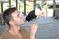 Man and his domesticated toucan bird
