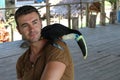 Man and his domesticated toucan bird Royalty Free Stock Photo