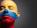 Man and his face painted with the flag of Colombia. Royalty Free Stock Photo