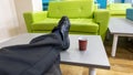 Man with his feet up on a table having a cup of coffee Royalty Free Stock Photo