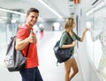 Man with his girlfriend are standing near map and choosing route