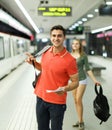 Man with his girlfriend are standing on platform and choosing route