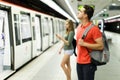 Man with his girlfriend are standing on platform and choosing route