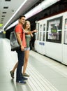 Man with his girlfriend are standing on platform and choosing route