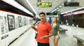 Man with his girlfriend are standing on platform and choosing route