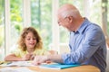 Man and his grandchild doing homework after school Royalty Free Stock Photo