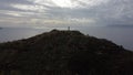 A man with his hand raised on top of an Kizil Ada island in the mediterranean sea