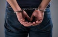 Man with his hands handcuffed in criminal concept