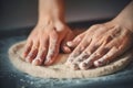 A man with his hands rolls out homemade pizza dough, lying on a dark baking tray. Cooking at home