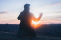 Man on his knees praying. On the background of the sunset sky. Kneeling Prayer to God. Worship Royalty Free Stock Photo