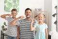 Man and his little children brushing teeth at home Royalty Free Stock Photo